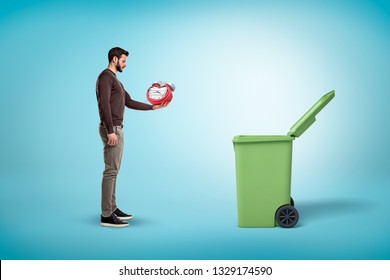 Man Throwing Broken Red Clock Into Open Trash Bin On Blue Background. Digital Art. People And Objects. Trash And Garbage.