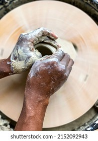 A Man Throwing A Clay Mug On A Potters Wheel