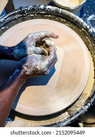 A Man Throwing A Clay Mug On A Potters Wheel