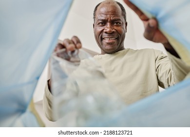 Man Throwing Garbage In Bucket