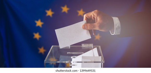 Man Throwing His Vote Into The Ballot Box. EU Elections. Elections To The European Parliament