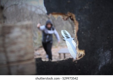 Man Throwing A Knife