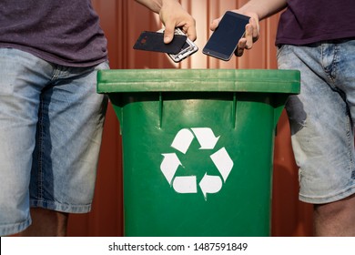 Man Throwing Phones Into Recycle Bin / Obsolete Technology, E Waste  