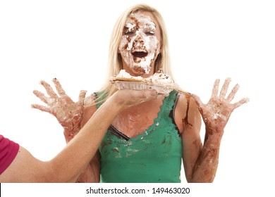 A Man Is Throwing A Pie In A Womans Face.