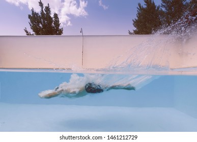 Man throws himself into the pool in a split view of water and air