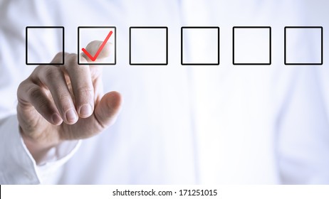 Man Ticking A Check Box In A Line Of Empty Boxes On A Virtual Screen Or Interface With His Finger