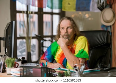 Man In Tie Dye Shirt At His Desk