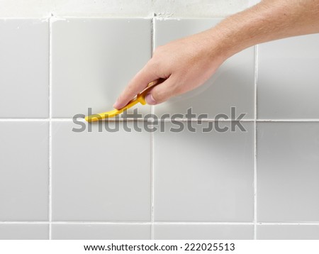 MAN TILING A WALL