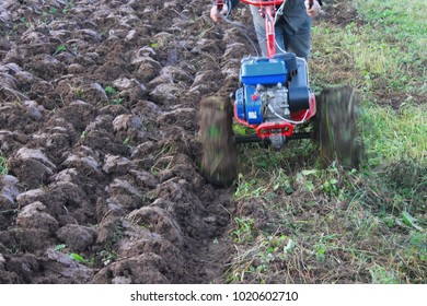 The Man Tills The Earth With The Motor Cultivator