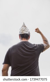 Man With A Tin Foil Hat On His Head Demonstrate Angry, Concept Conspiracy And Paranoia, Copyspace