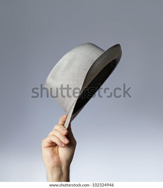 Man tipping his vintage\
trilby hat.