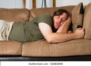 Man Tired He Falls Asleep On The Couch