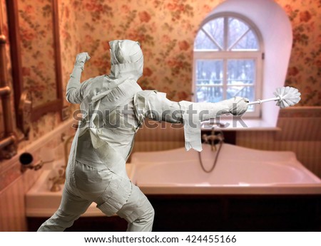 Man in toilet paper with toiletbrush
