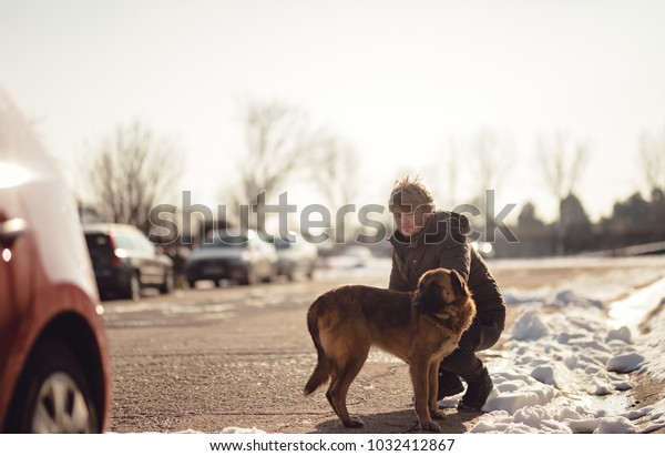 The\
man took his puppy out for a walk, the dog in the leash is walked\
by his master, the blond boy walks his brown dog on the street, the\
master walks his dog in the leash during the\
winter