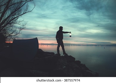 Man With A Torch Camping In The Lake At Night