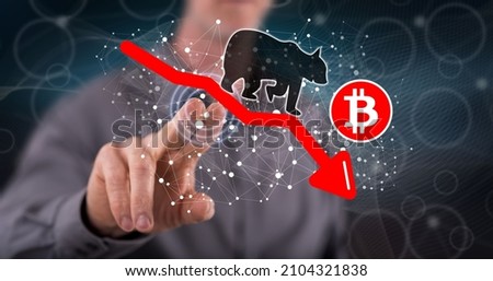 Man touching a bitcoin bearish trend concept on a touch screen with his finger