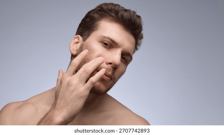 Man touching cheek while checking healing nose bandage. Concept of recovery guidance, postoperative education, clinic follow-up visuals, and healing-stage demonstration materials.