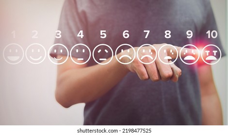 man touching cry of pain scale icons virtual screen interface, medical technology and futuristic concept.