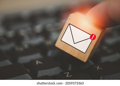 Man touching cube block with envelope and notifications symbol icon for the new E-Mail message inbox. The concept of computer browsing communication