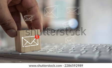 Man touching cube block with envelope and notifications symbol icon for the new E-Mail message inbox. The concept of computer browsing communication