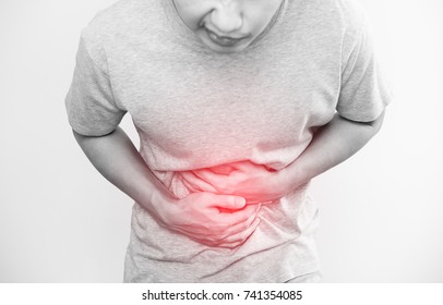 a man touching his stomach, red highlight concept of stomach pain and others stomach disease