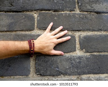 A man touching the old bricks wall from Xi’an shanxi province China.