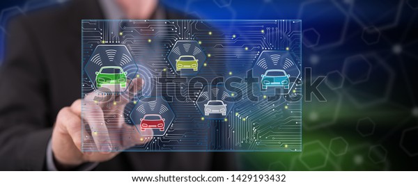 Man touching a smart car concept on a touch screen\
with his finger