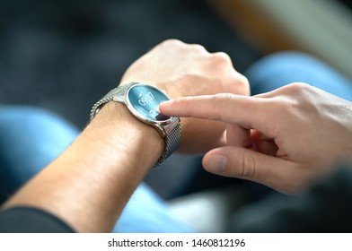 Man Touching Smart Watch Screen To Open Notification And Read Message. Wearable Hybrid Mobile Device, Gadget And Activity Tracker In Wrist. Wearing Digital Smartwatch In Hand. People With Wearables.