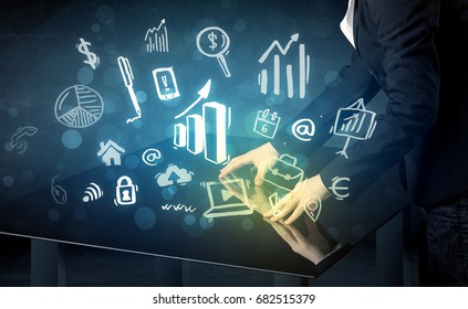 Man touching technology smart table with business icons and symbols