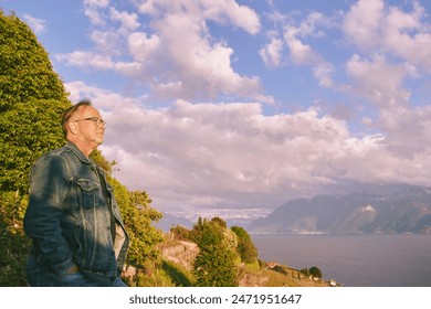 Man tourist admiring vneyard terraces on Lake Geneva in summer, Lavaux, Vaud, Switzerland - Powered by Shutterstock