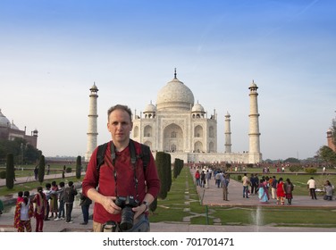 The Man, The Tourist With The Camera Smiles On The Background Of Taj Mahal

