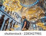 Man tourist enjoying Hagia Sofia, Ayasofya interior in Istanbul, Turkey, Byzantine architecture, city landmark and architectural world wonder. Turkiye
