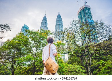 Man Tourist In Malaysia Looks At The Petronas Twin Towers.