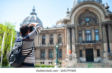 Man Tourist Photographing An Attraction In Bucharest During A Summer Sunny Day