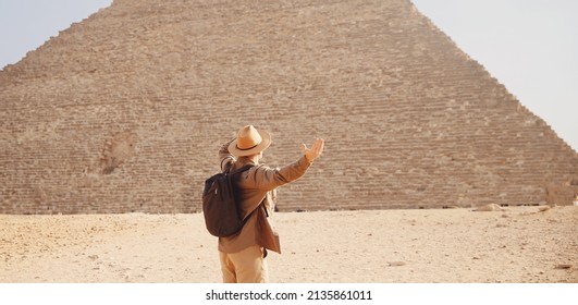 Man tourist walks background of pyramids in Giza Cairo Egypt, sun light travel banner.