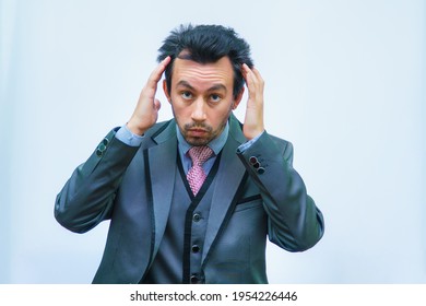 A Man With Tousled Hair In A Business Suit Straightens His Hair