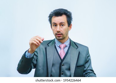 A Man With Tousled Hair In A Business Suit Straightens His Hair