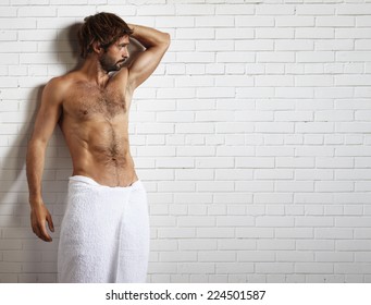 Man In Towel And Brick Wall Behind