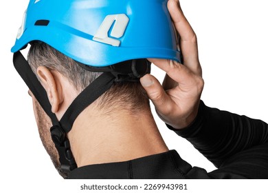 Man, tower worker. Work at height. Tourist, climber. Dressing and adjusting a helmet, a protective helmet. Isolated on white background. - Powered by Shutterstock