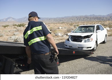 Man Towing Damaged Car Away