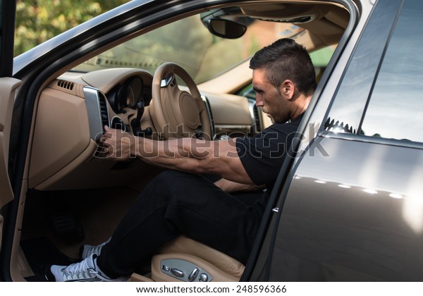 Man In A Track Suit\
Driving In The Car