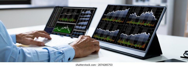 Man Trading Stock Market Exchange Online On Multiple laptop Computers - Shutterstock ID 2074285753