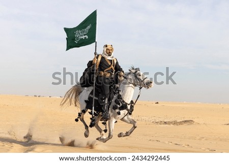 Man in traditional clothing with his horse in a desert