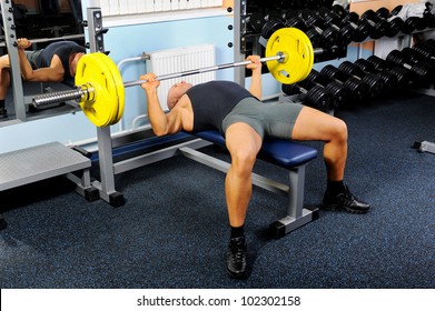 Man Trained In The Gym Bar Bench Press