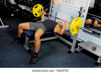 Man Trained In The Gym Bar Bench Press