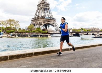 Man training and doing fitness exercises along the Seine river in Paris with Eiffel tower on background - Multiracial young man enjoying sport on a sunny day - Powered by Shutterstock