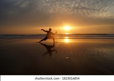 Man training martial arts at the beach during sunset, Peniche, Portugal - Powered by Shutterstock