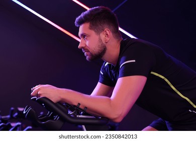 Man training on exercise bike in fitness club - Powered by Shutterstock