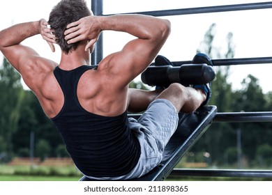 Man Training On The Outdoor Gym, Horizontal