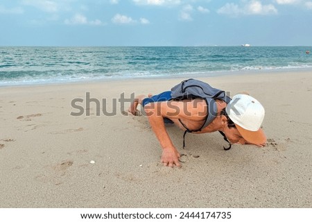 man training outdoors with a backpack with weights. Rucking as a popular form of exercise with weight on your back